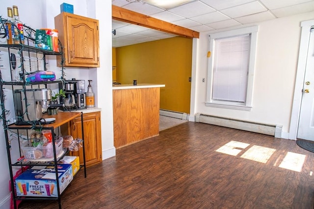 indoor bar featuring wood finished floors, a baseboard radiator, a drop ceiling, and baseboards