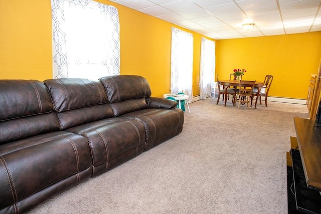 living area with carpet flooring and a baseboard heating unit