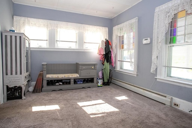 bedroom with multiple windows, carpet floors, and a baseboard radiator