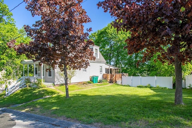 view of yard featuring stairway, a sunroom, and covered porch