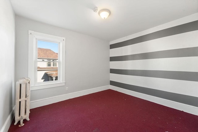 carpeted empty room with radiator heating unit