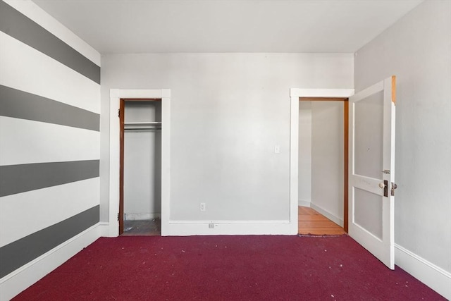 unfurnished bedroom featuring carpet floors and a closet