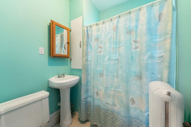 bathroom featuring a shower with curtain, sink, tile patterned flooring, radiator heating unit, and toilet