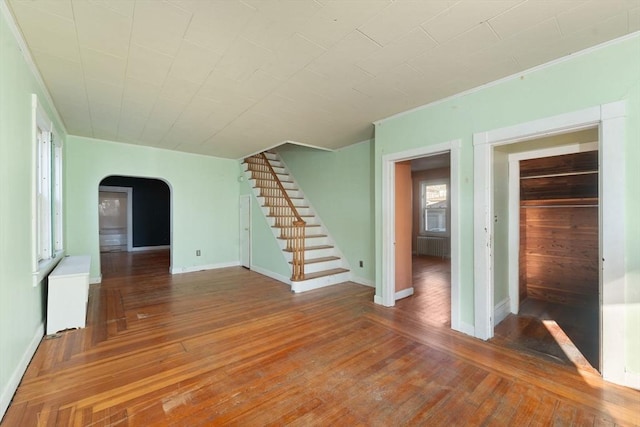 interior space featuring radiator heating unit, dark hardwood / wood-style flooring, and ornamental molding