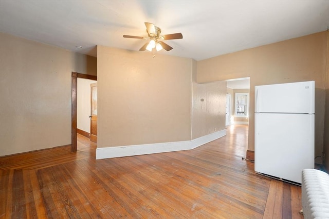 empty room featuring hardwood / wood-style flooring and ceiling fan