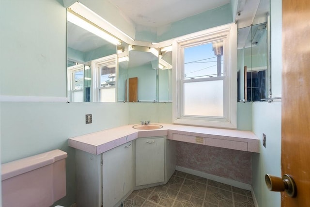 bathroom featuring vanity and toilet