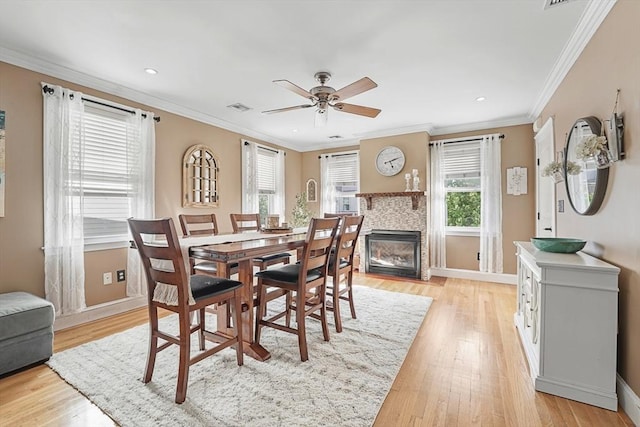 dining room featuring ceiling fan, ornamental molding, and light hardwood / wood-style flooring