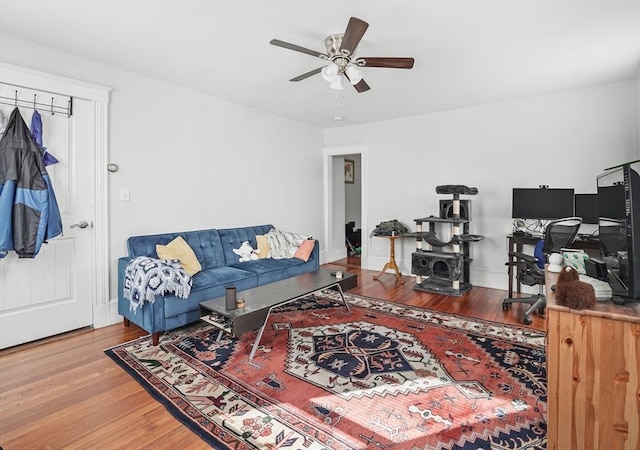 living room with ceiling fan and wood-type flooring