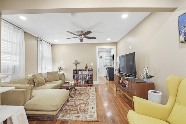 living room with hardwood / wood-style flooring, ceiling fan, and a healthy amount of sunlight