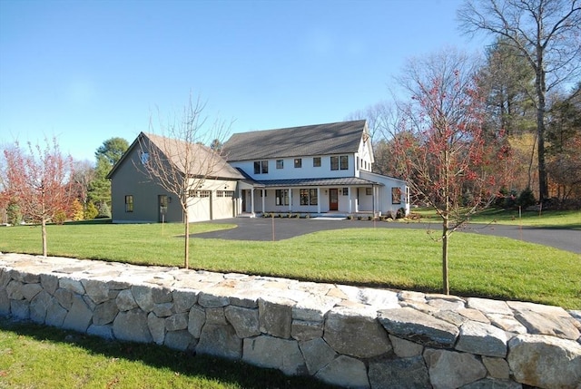 view of front of home featuring a front yard and a garage