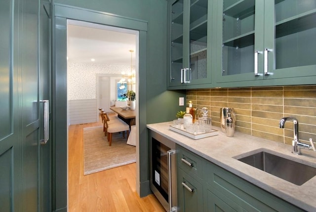 bar with sink and green cabinetry