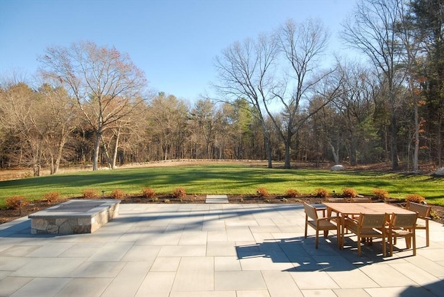 surrounding community with a yard and a patio area