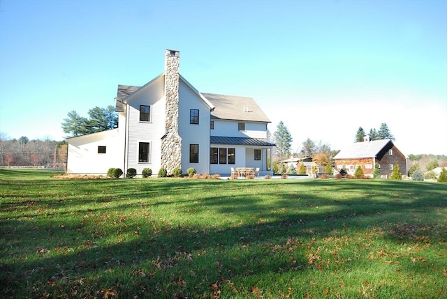 rear view of house with a yard