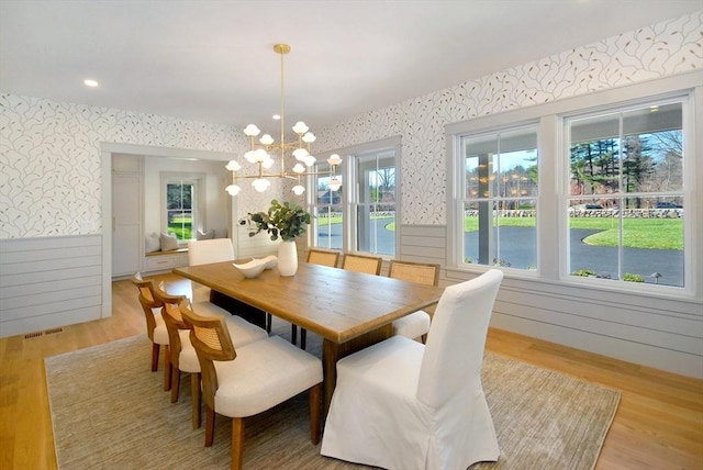 dining space featuring a chandelier, a healthy amount of sunlight, and light wood-type flooring