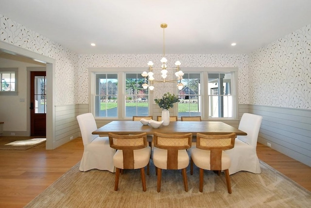 dining area featuring light hardwood / wood-style flooring and a notable chandelier