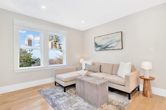 living room with plenty of natural light and light hardwood / wood-style floors