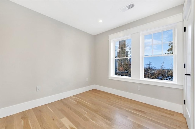 spare room with light hardwood / wood-style flooring