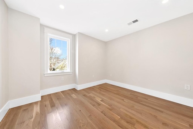 spare room featuring light hardwood / wood-style floors