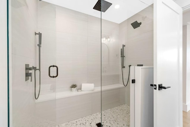 bathroom with a shower with door