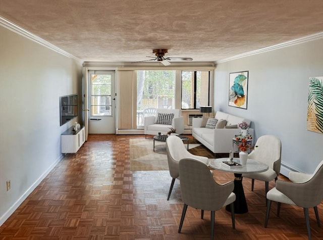 living room with ceiling fan, dark parquet floors, a baseboard heating unit, and ornamental molding