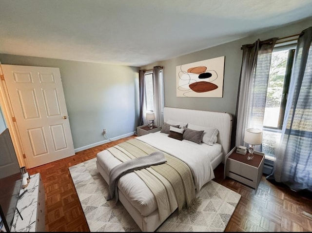 bedroom featuring parquet flooring