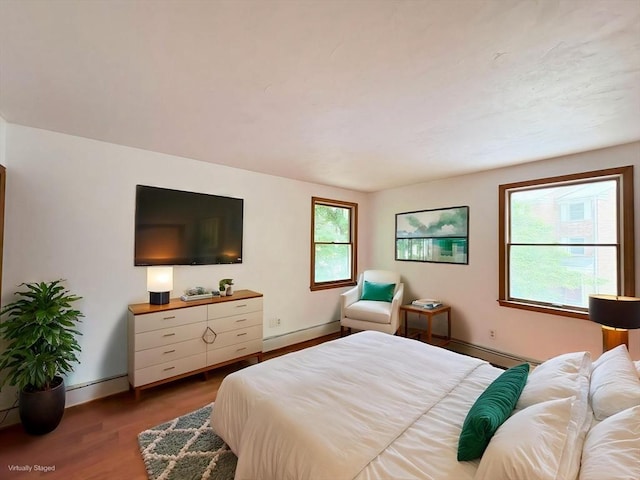 2 Robert Cohen Dr, Canton, MA 02021 - bedroom featuring wood finished floors, baseboards, a baseboard heating unit, and baseboard heating