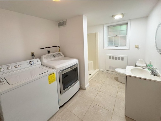 2 Robert Cohen Dr, Canton, MA 02021 - laundry area featuring radiator heating unit, washing machine and clothes dryer, and light tile patterned floors