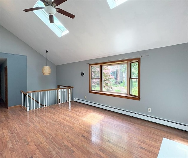 2 Robert Cohen Dr, Canton, MA 02021 - unfurnished room with a skylight, a baseboard heating unit, vaulted ceiling, ceiling fan, and wood finished floors