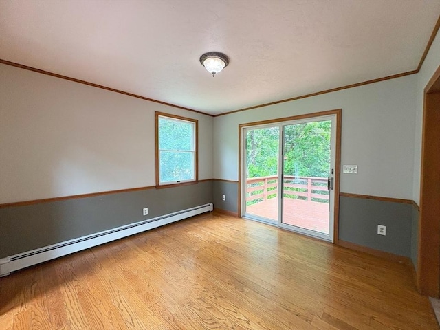 2 Robert Cohen Dr, Canton, MA 02021 - spare room featuring a baseboard heating unit, crown molding, light wood-style flooring, and baseboards