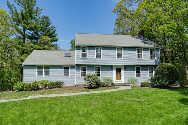 colonial house with a front lawn and a chimney