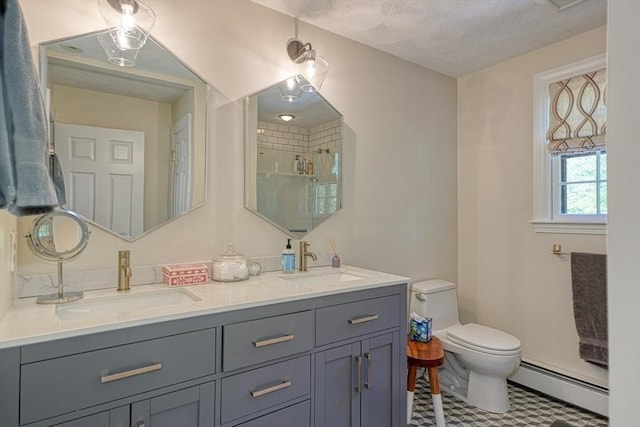 full bathroom with baseboard heating, toilet, a shower stall, double vanity, and baseboards