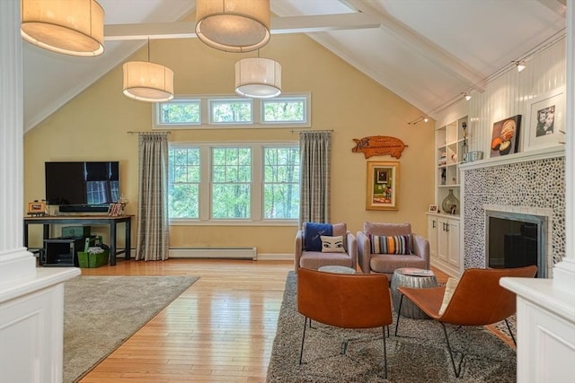 living area with light wood-style floors, beam ceiling, high vaulted ceiling, a fireplace, and baseboard heating