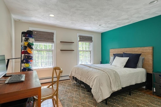 bedroom featuring a baseboard radiator, a textured ceiling, wood finished floors, and recessed lighting