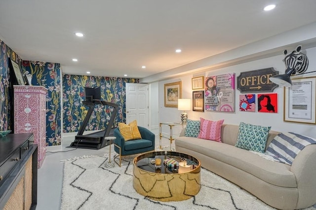 living area featuring wallpapered walls, concrete flooring, and recessed lighting