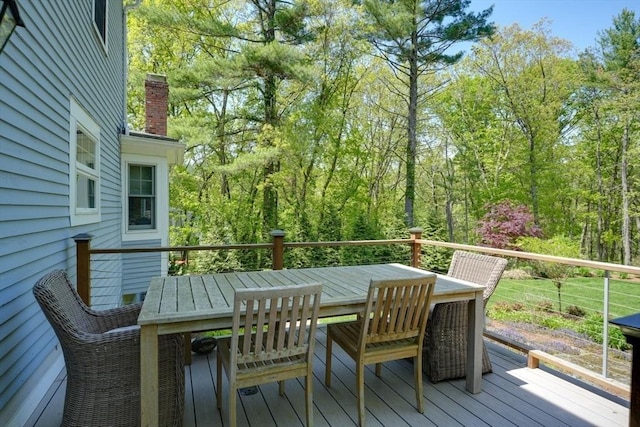 wooden terrace with outdoor dining area