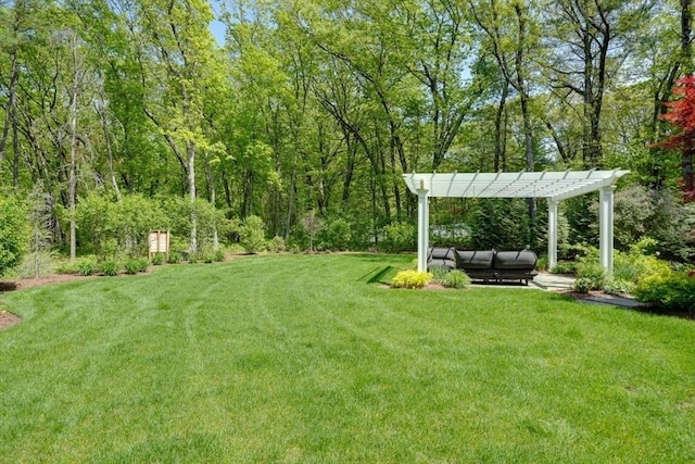 view of green lawn featuring a pergola and outdoor lounge area