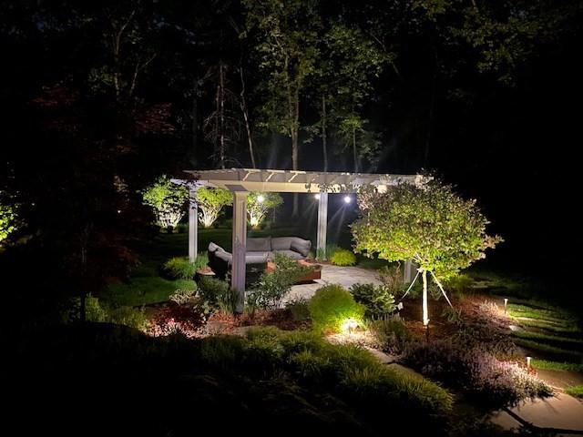 view of home's community with a pergola and an outdoor hangout area
