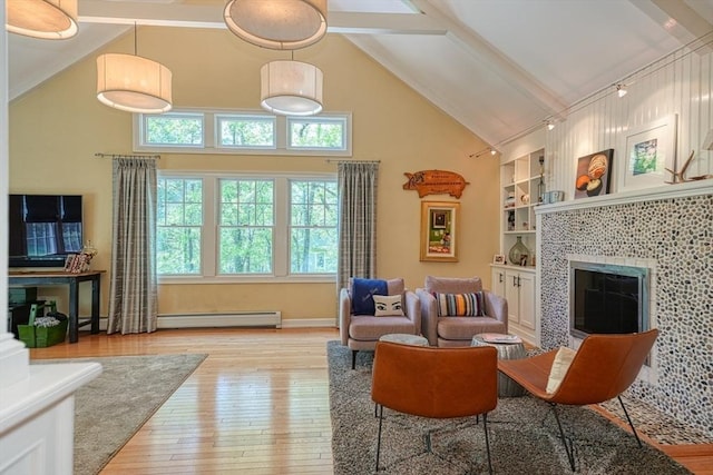 living area featuring a baseboard heating unit, high vaulted ceiling, light wood-type flooring, beamed ceiling, and a tile fireplace