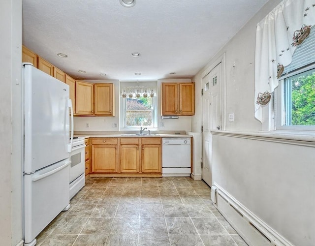 68-70 Floyd St, Winthrop, MA 02152 - kitchen with light countertops, plenty of natural light, a baseboard heating unit, and white appliances
