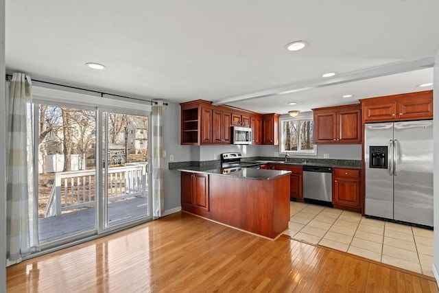 kitchen with recessed lighting, appliances with stainless steel finishes, a peninsula, light wood-style floors, and open shelves