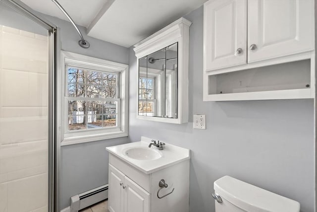 bathroom featuring toilet, vanity, and a baseboard heating unit