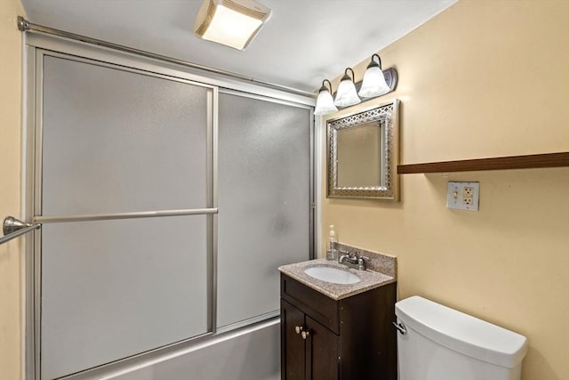 full bathroom with vanity, toilet, and shower / bath combination with glass door