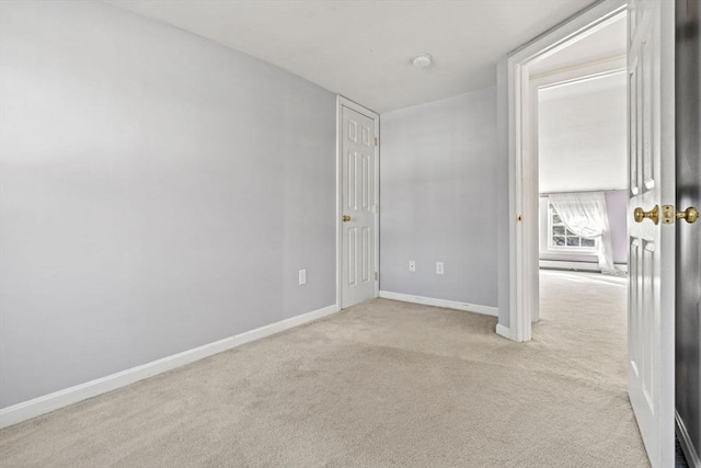 unfurnished room with baseboards and carpet floors