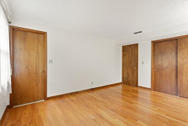 82 Neponset St Unit E, Canton, MA 02021 - unfurnished bedroom with light wood finished floors and baseboards