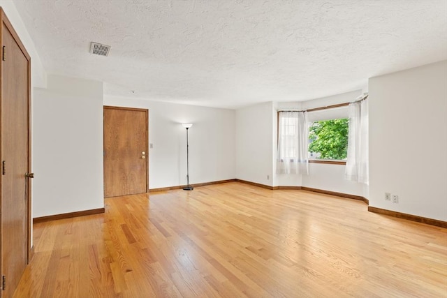 82 Neponset St Unit E, Canton, MA 02021 - unfurnished room featuring light wood-style flooring, a textured ceiling, and baseboards