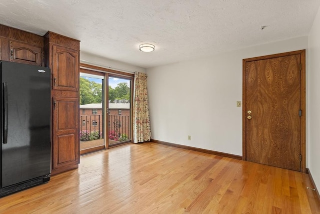 82 Neponset St Unit E, Canton, MA 02021 - unfurnished room with light wood-style floors, baseboards, and a textured ceiling