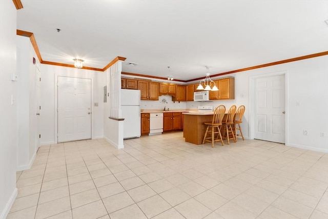 kitchen featuring white appliances, brown cabinetry, a peninsula, ornamental molding, and light countertops