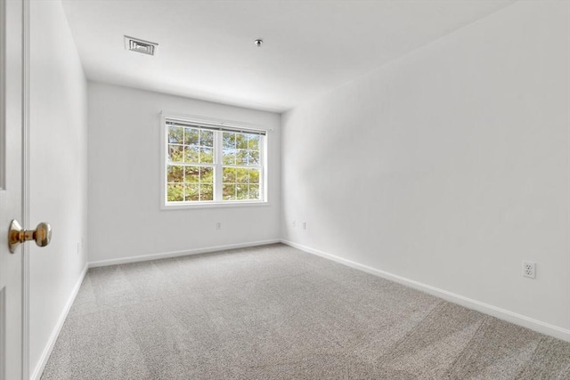 unfurnished room with baseboards, visible vents, and carpet floors