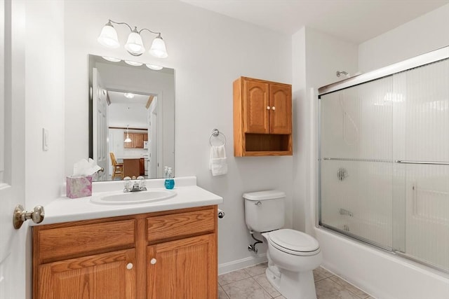 full bathroom featuring toilet, tile patterned floors, vanity, and bath / shower combo with glass door