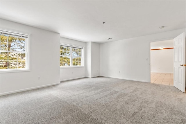 empty room featuring baseboards and carpet floors
